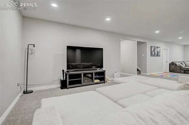 a bedroom with furniture and flat screen tv