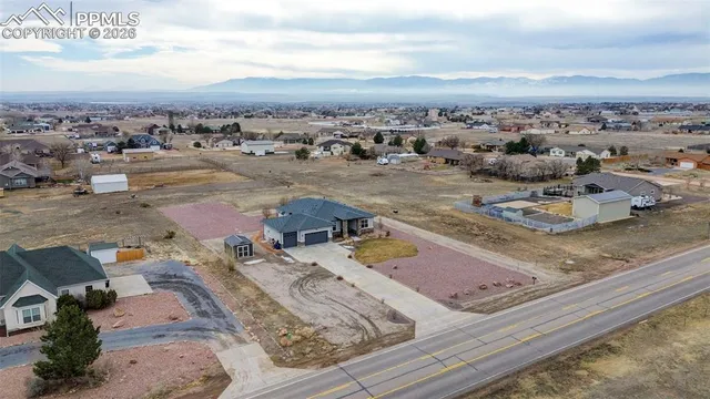 an aerial view of a house with a swimming pool