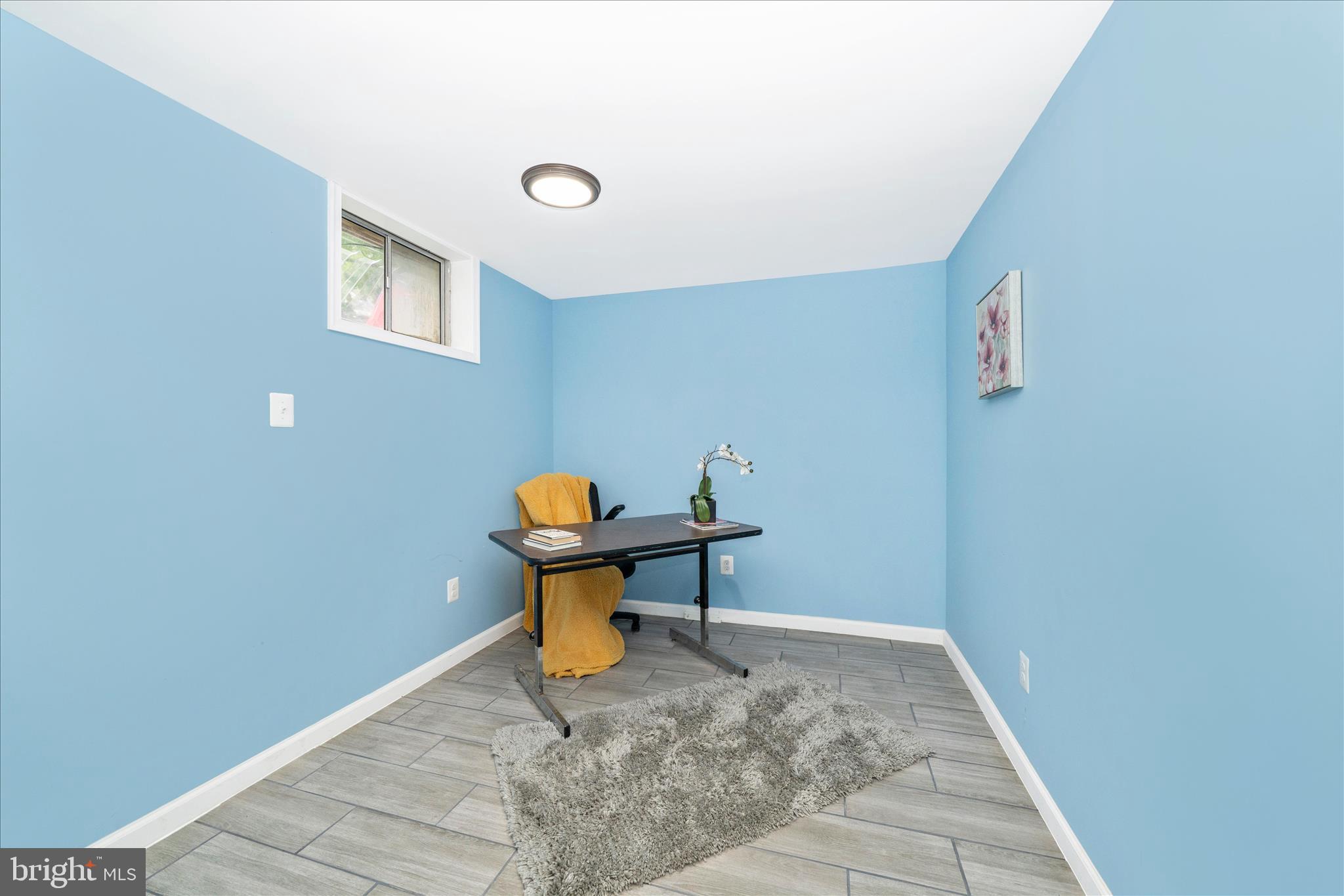 713 Seek Lane Silver Spring, MD 20912 - Photo 34 of 60 a view of a hallway that has a bench and a table in it