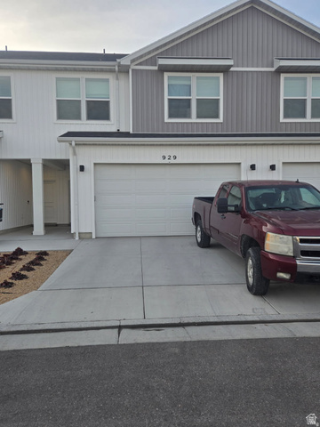 929 North 960 West Tremonton, UT 84337 - Photo 2 of 20 Contemporary townhome exterior featuring dual-tone vertical siding and a prominent two-car garage