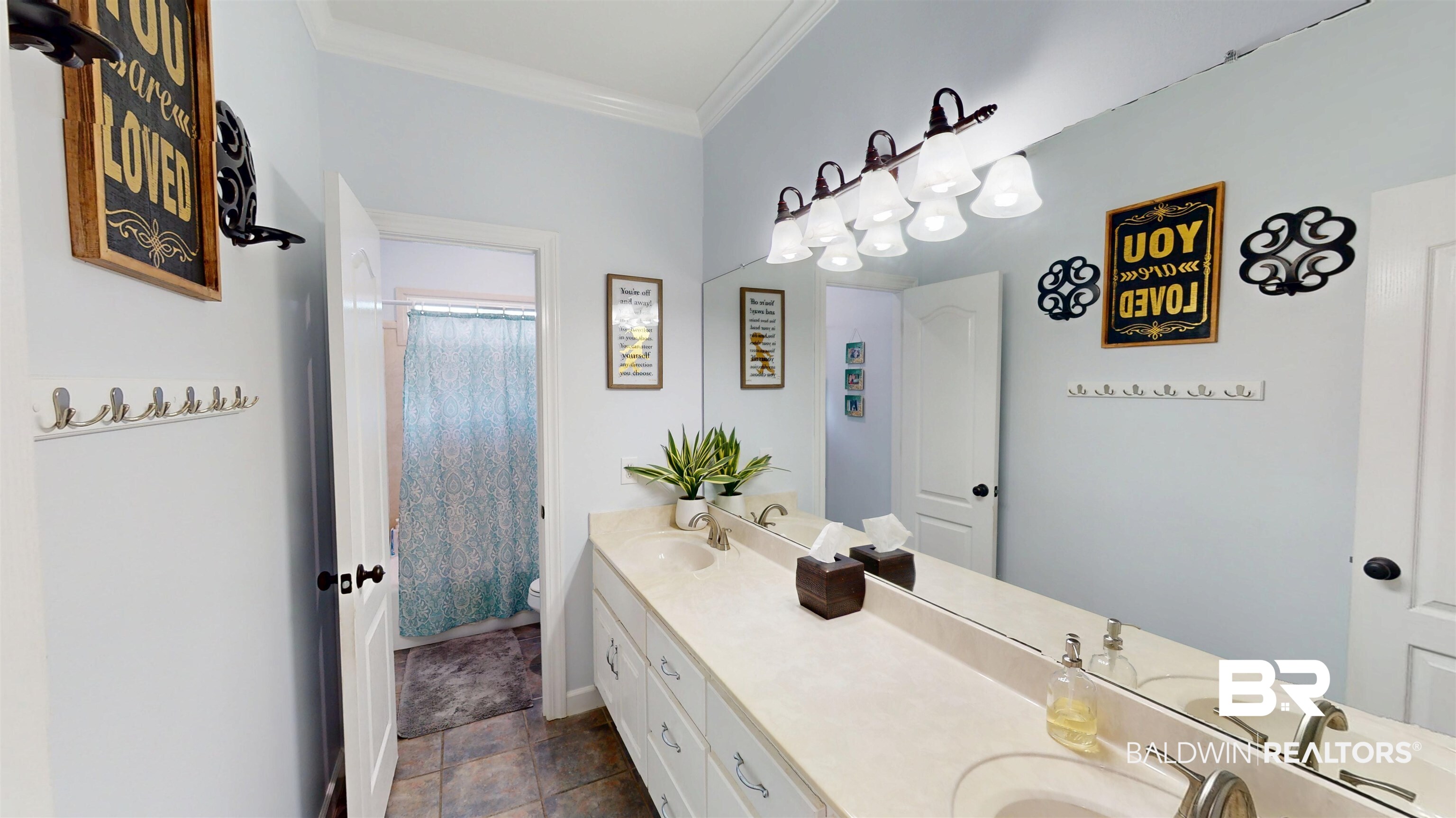 8775 Dawes Lake Road North Mobile, AL 36619 - Photo 33 of 59 Bathroom featuring double vanity, crown molding, a shower with shower curtain, and stone finish flooring