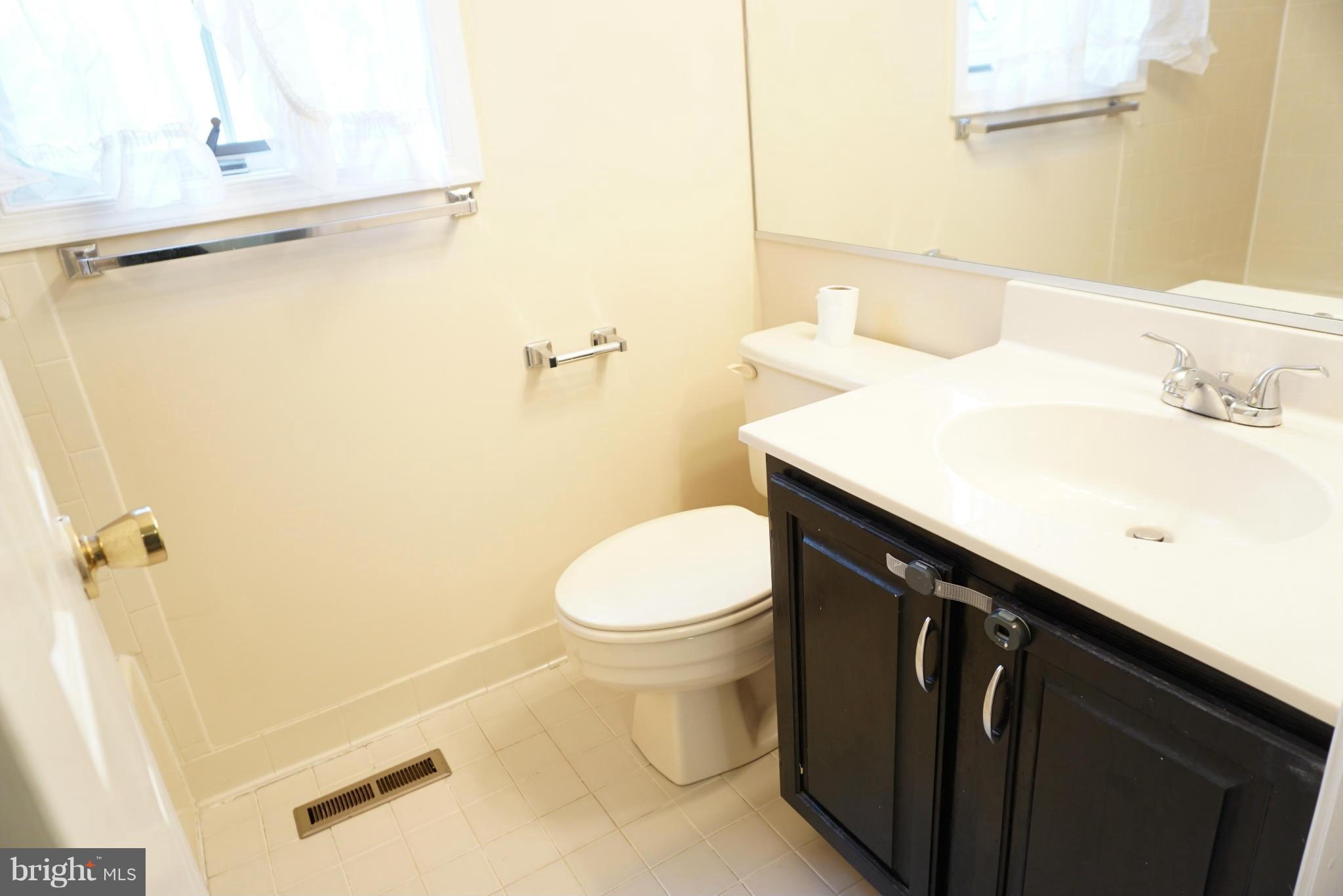 14405 Colonels Choice Road Upper Marlboro, MD 20772 - Photo 13 of 18 a bathroom with a sink and a toilet