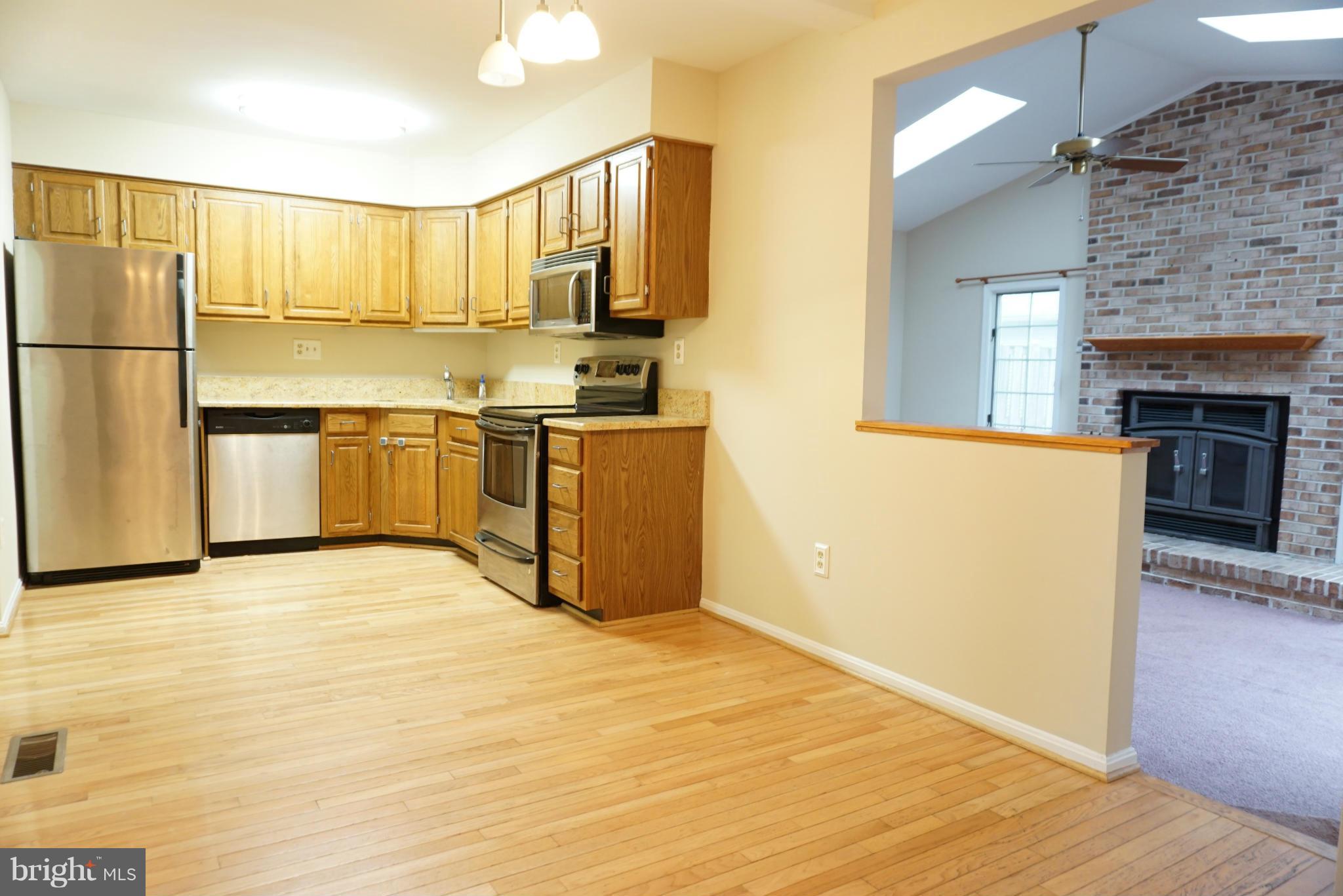 14405 Colonels Choice Road Upper Marlboro, MD 20772 - Photo 4 of 18 a kitchen with stainless steel appliances granite countertop a refrigerator and a stove top oven