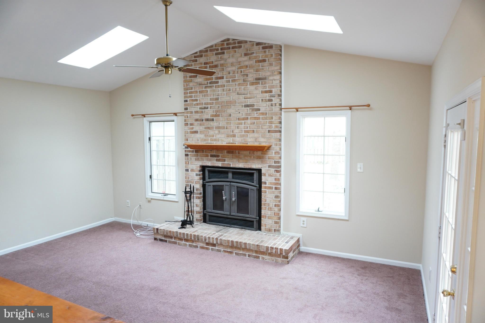 14405 Colonels Choice Road Upper Marlboro, MD 20772 - Photo 6 of 18 an empty room with windows and fireplace