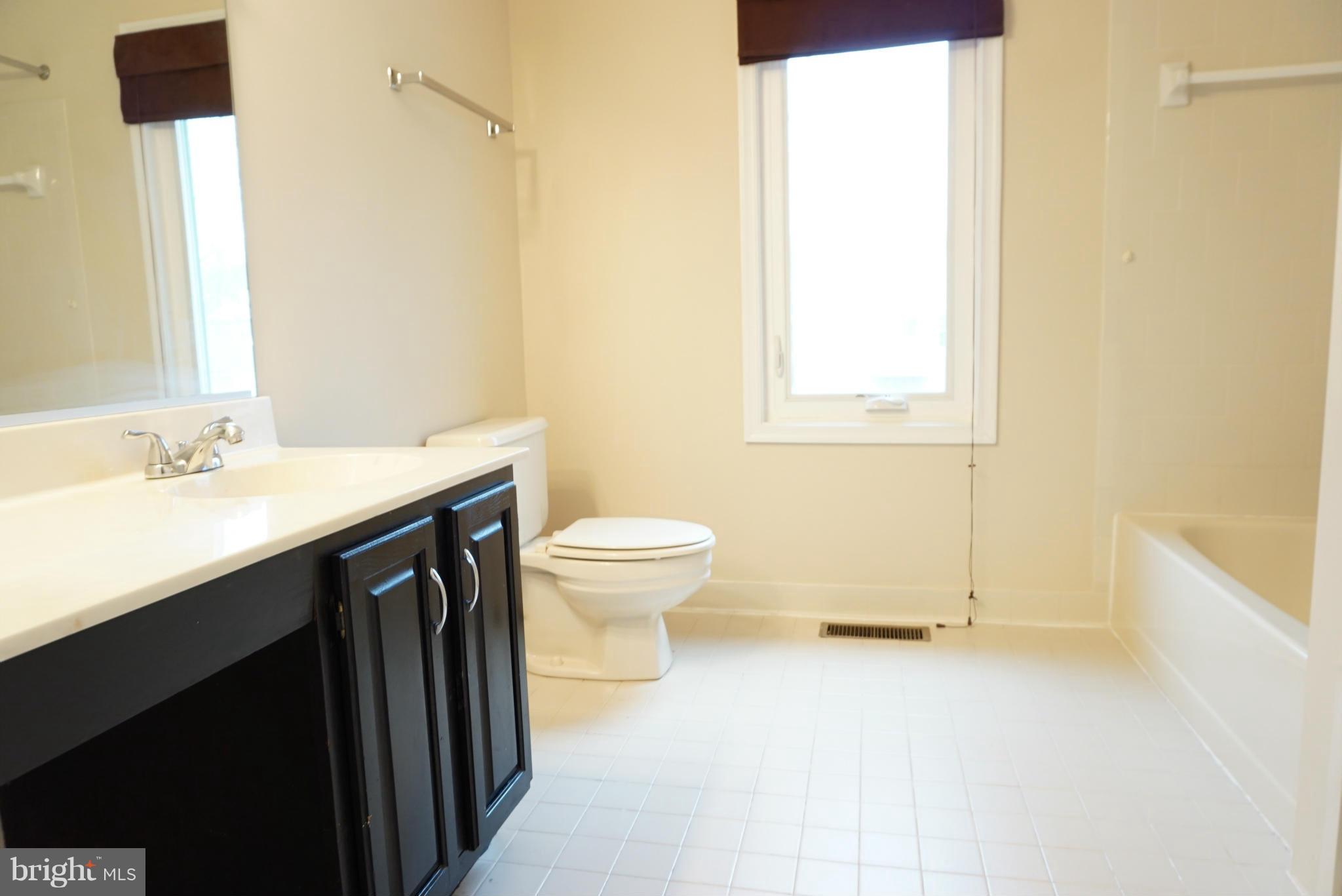 14405 Colonels Choice Road Upper Marlboro, MD 20772 - Photo 10 of 18 a bathroom with a sink a toilet and shower