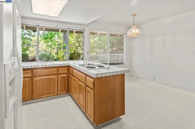 a kitchen that has a stove a sink and a refrigerator