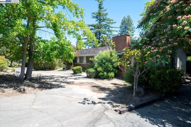 a view of a house with a yard and tree s