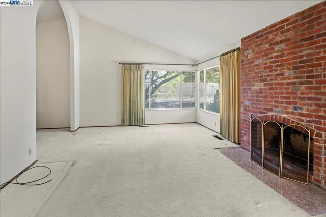 a view of empty room with a fireplace
