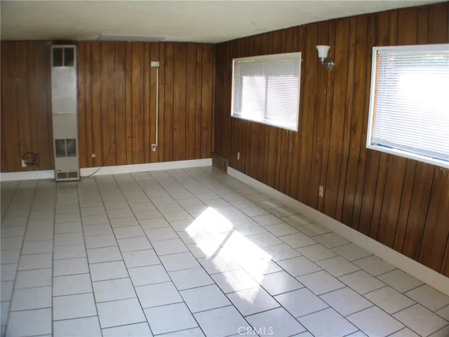 a view of a hallway with wooden walls and entryway