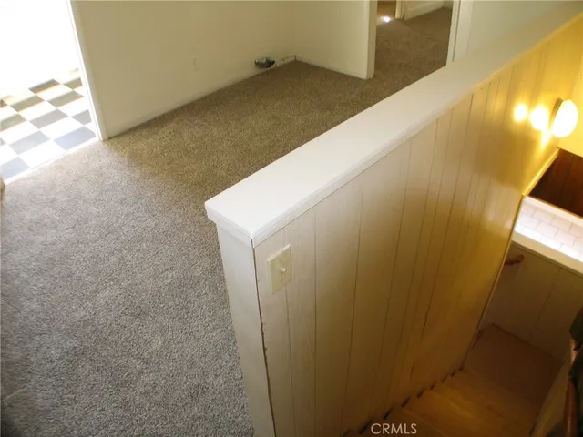 a kitchen with a checkered floor and white cabinets