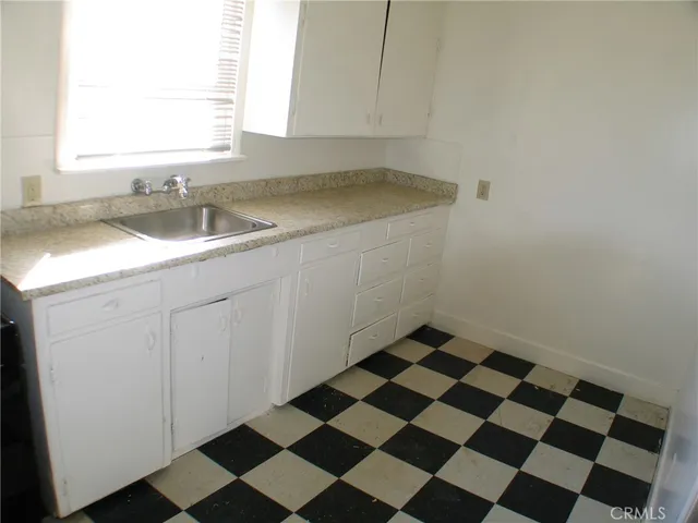 a stove top oven sitting inside of a kitchen