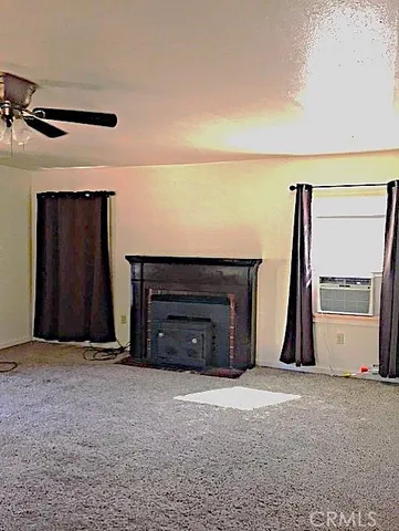 a view of a livingroom with a fireplace and a large window