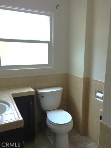 a bathroom with a toilet sink and window