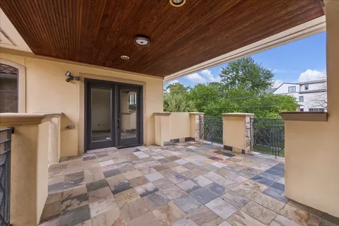 a view of backyard with potted plants and wooden fence