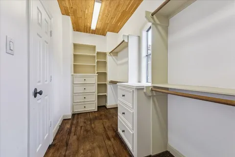 a spacious bathroom with a granite countertop sink a toilet a mirror and tub