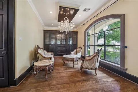 a living room with furniture and a floor to ceiling window