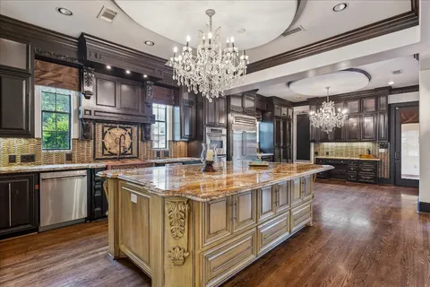a kitchen with stainless steel appliances granite countertop a sink and stove