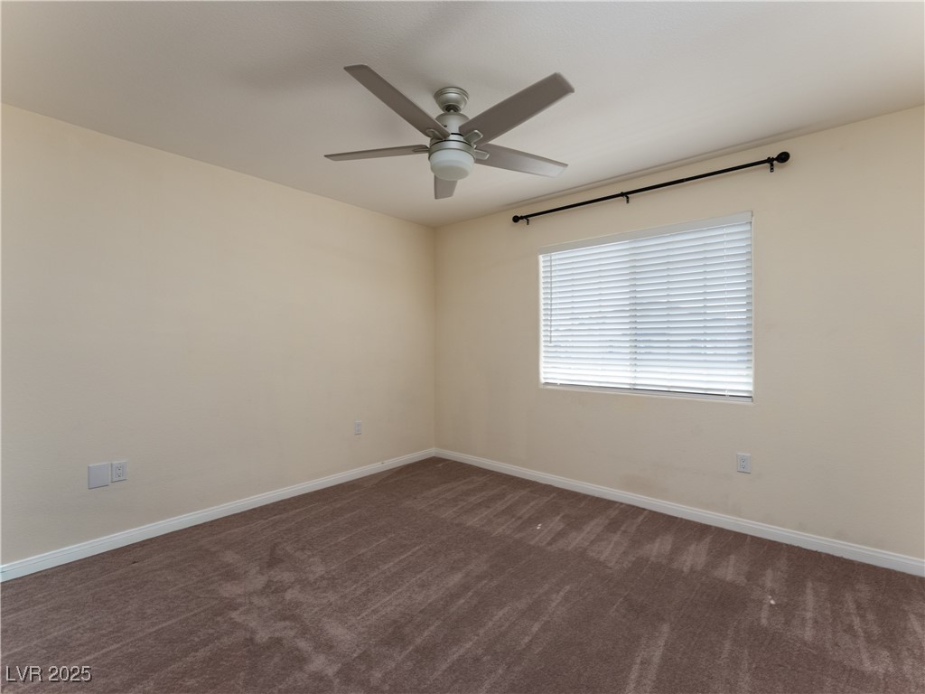 3318 North Decatur Boulevard, Unit 2149 Las Vegas, NV 89130 - Photo 18 of 26 Spare room with dark carpet and ceiling fan
