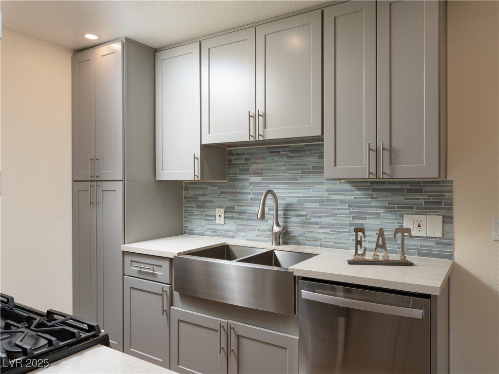 3318 North Decatur Boulevard, Unit 2149 Las Vegas, NV 89130 - Photo 2 of 26 Kitchen with gray cabinetry, dishwasher, decorative backsplash, light stone counters, and recessed lighting