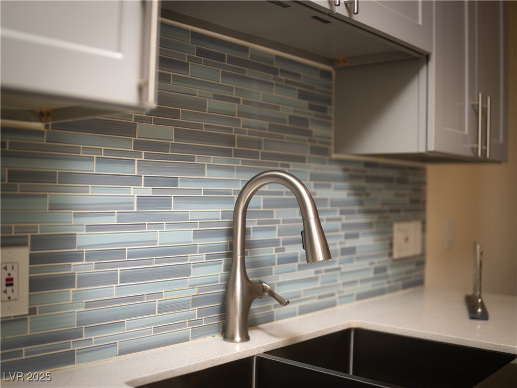 3318 North Decatur Boulevard, Unit 2149 Las Vegas, NV 89130 - Photo 5 of 26 Kitchen view of decorative backsplash and light stone countertops