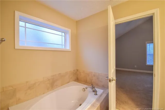 a bathroom with a bathtub and shower