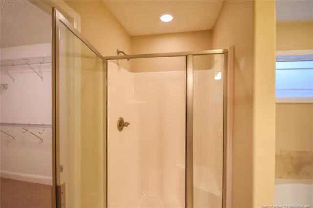 a bathroom with a shower and a glass door