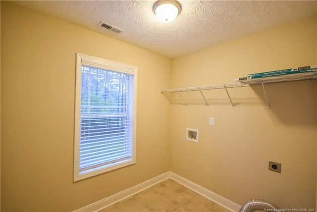 a view of a storage & utility room with a window