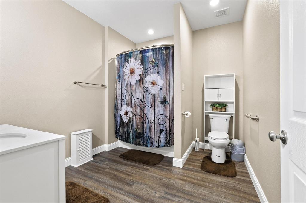 2658 Oak Ridge Road Denison, TX 75021 - Photo 23 of 37 a view of a hallway with bathroom and wooden floor