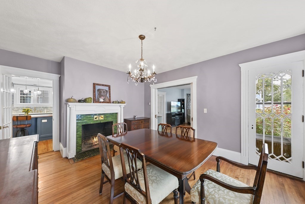 20 Columbus Avenue Beverly, MA 01915 - Photo 12 of 39 a dining room with furniture a fireplace and wooden floor