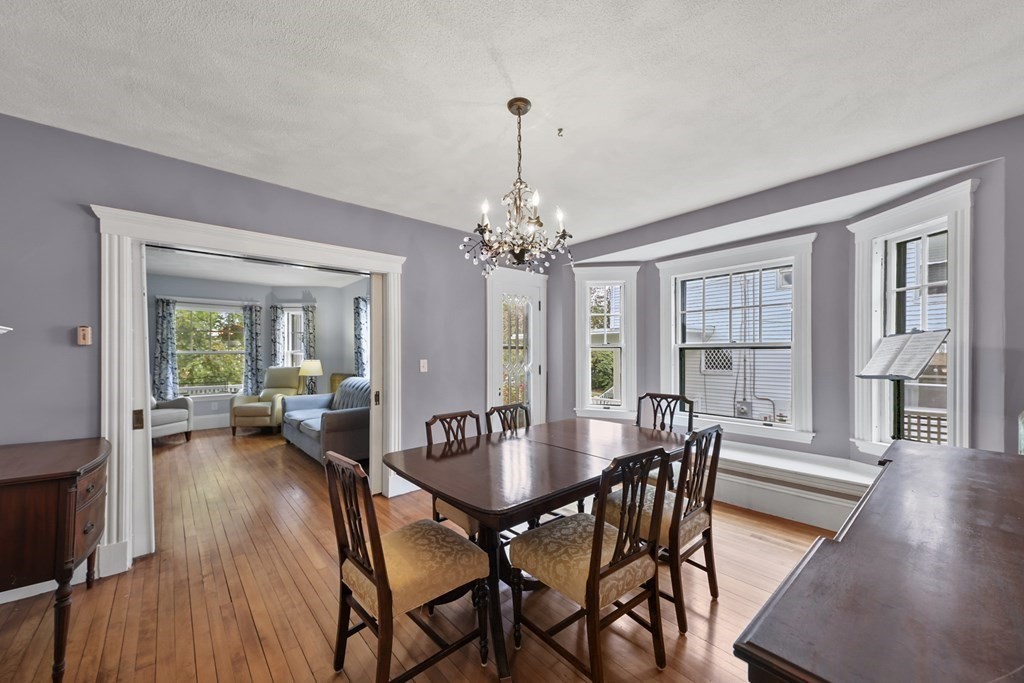 20 Columbus Avenue Beverly, MA 01915 - Photo 13 of 39 a view of a dining room with furniture wooden floor and chandelier