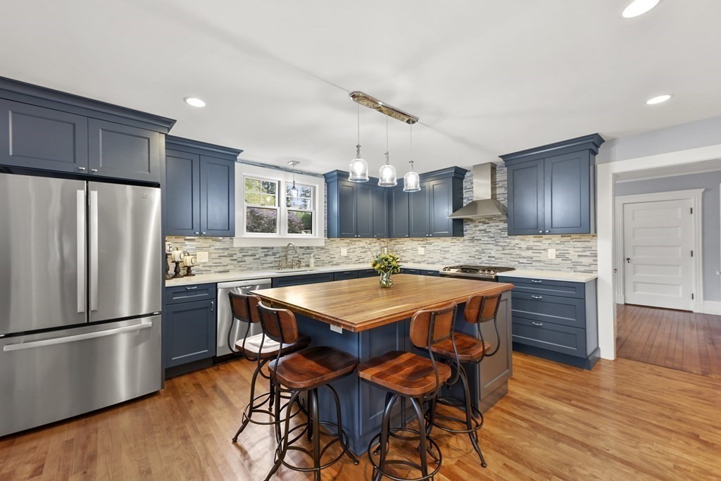 20 Columbus Avenue Beverly, MA 01915 - Photo 15 of 39 a kitchen with granite countertop stainless steel appliances a refrigerator and wooden cabinets