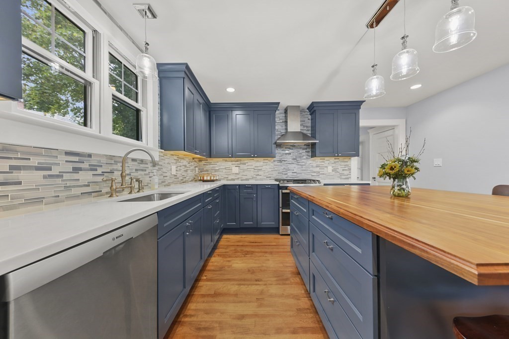 20 Columbus Avenue Beverly, MA 01915 - Photo 17 of 39 a large kitchen with granite countertop a sink and a stove