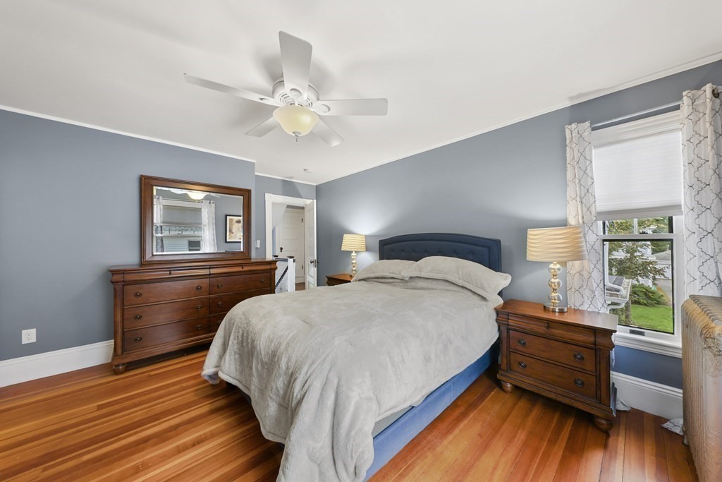 20 Columbus Avenue Beverly, MA 01915 - Photo 23 of 39 a bedroom with a bed and a large window with wooden floor