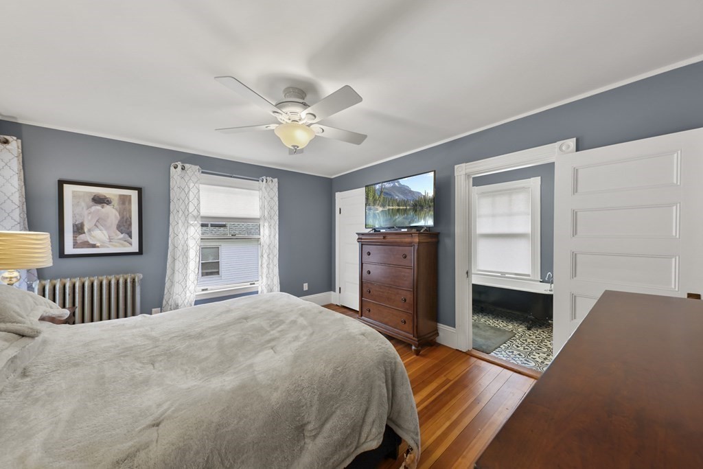 20 Columbus Avenue Beverly, MA 01915 - Photo 24 of 39 a bedroom with a bed and a chandelier