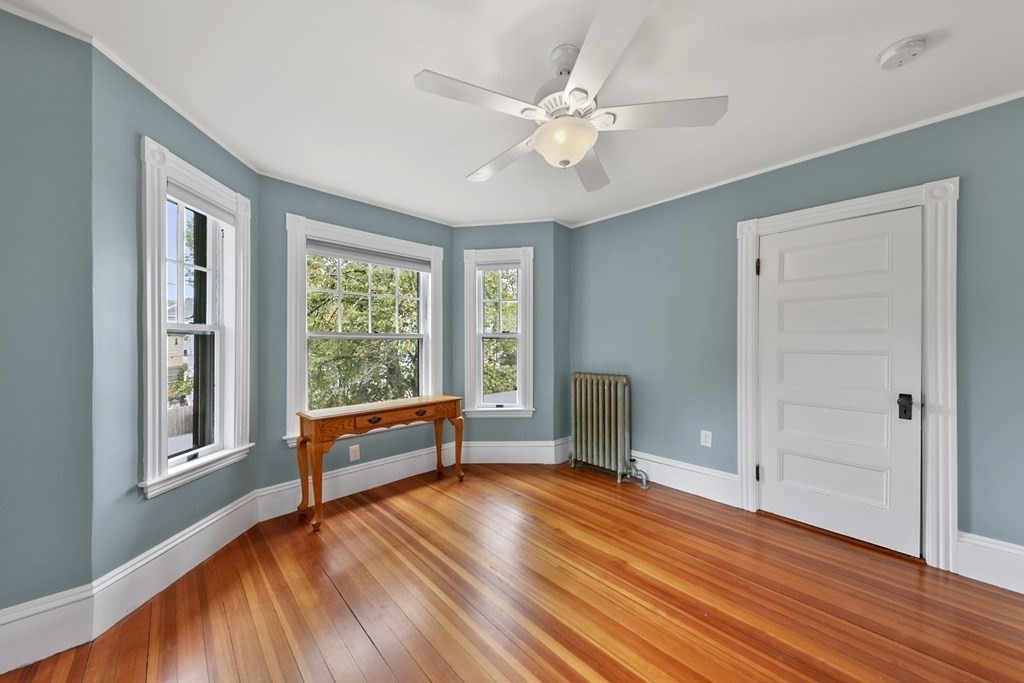 20 Columbus Avenue Beverly, MA 01915 - Photo 28 of 39 an empty room with wooden floor fan and windows