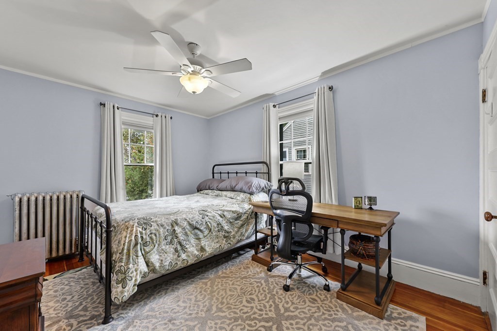 20 Columbus Avenue Beverly, MA 01915 - Photo 31 of 39 a bedroom with a bed and a chandelier