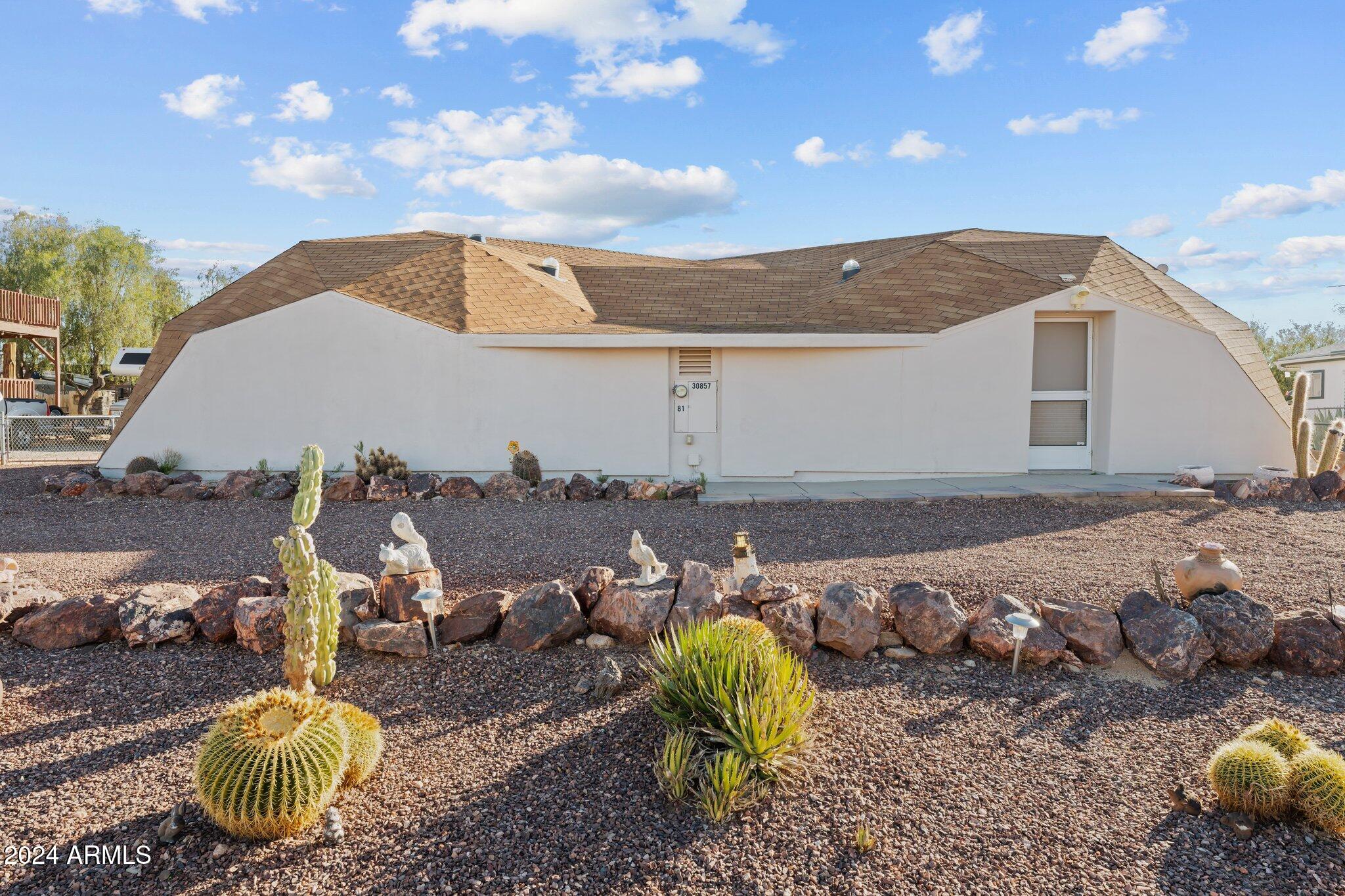 30857 Wandering Way Congress, AZ 85332 - Photo 1 of 35 a view of a backyard with floor to ceiling window and outdoor kitchen