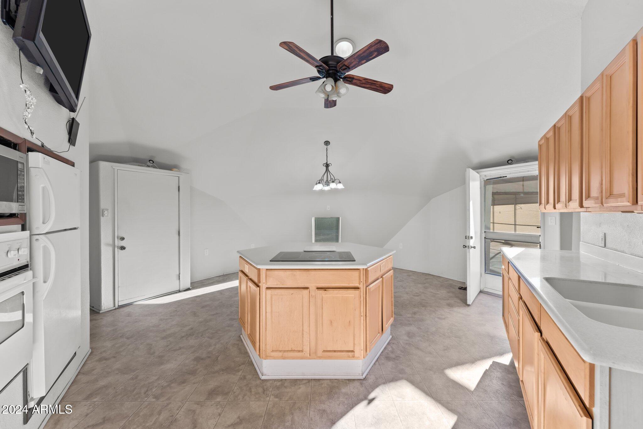 30857 Wandering Way Congress, AZ 85332 - Photo 16 of 35 a kitchen with stainless steel appliances granite countertop a sink stove and a refrigerator