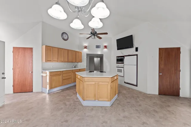 a living room with kitchen island granite countertop furniture and a fireplace