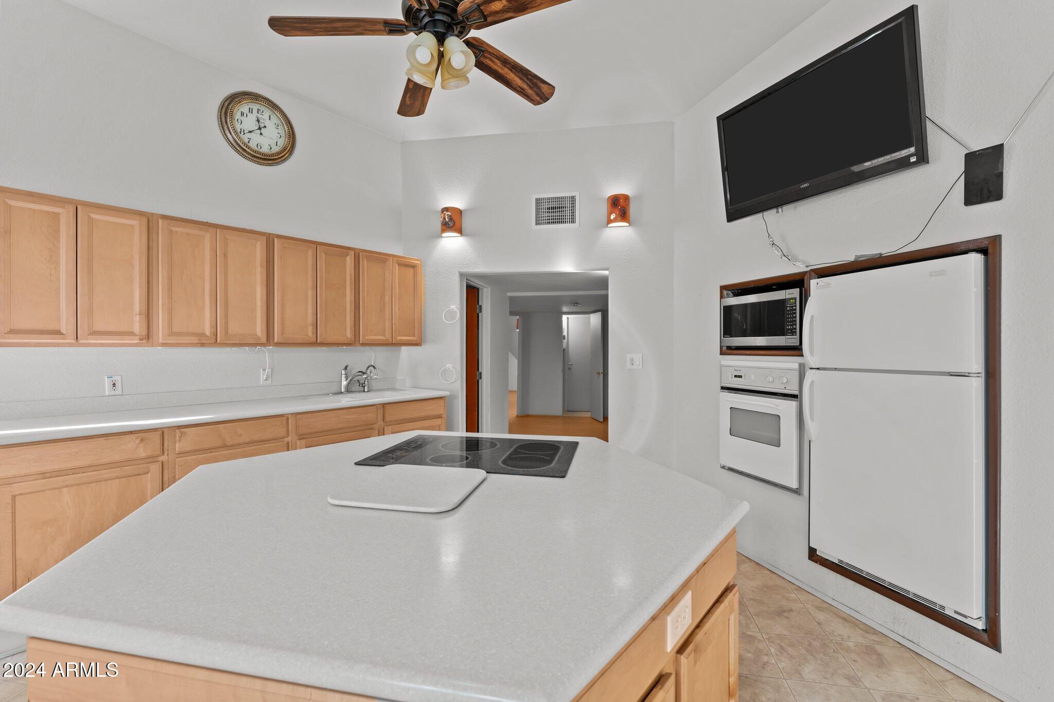 30857 Wandering Way Congress, AZ 85332 - Photo 18 of 35 a room with table and flat screen tv