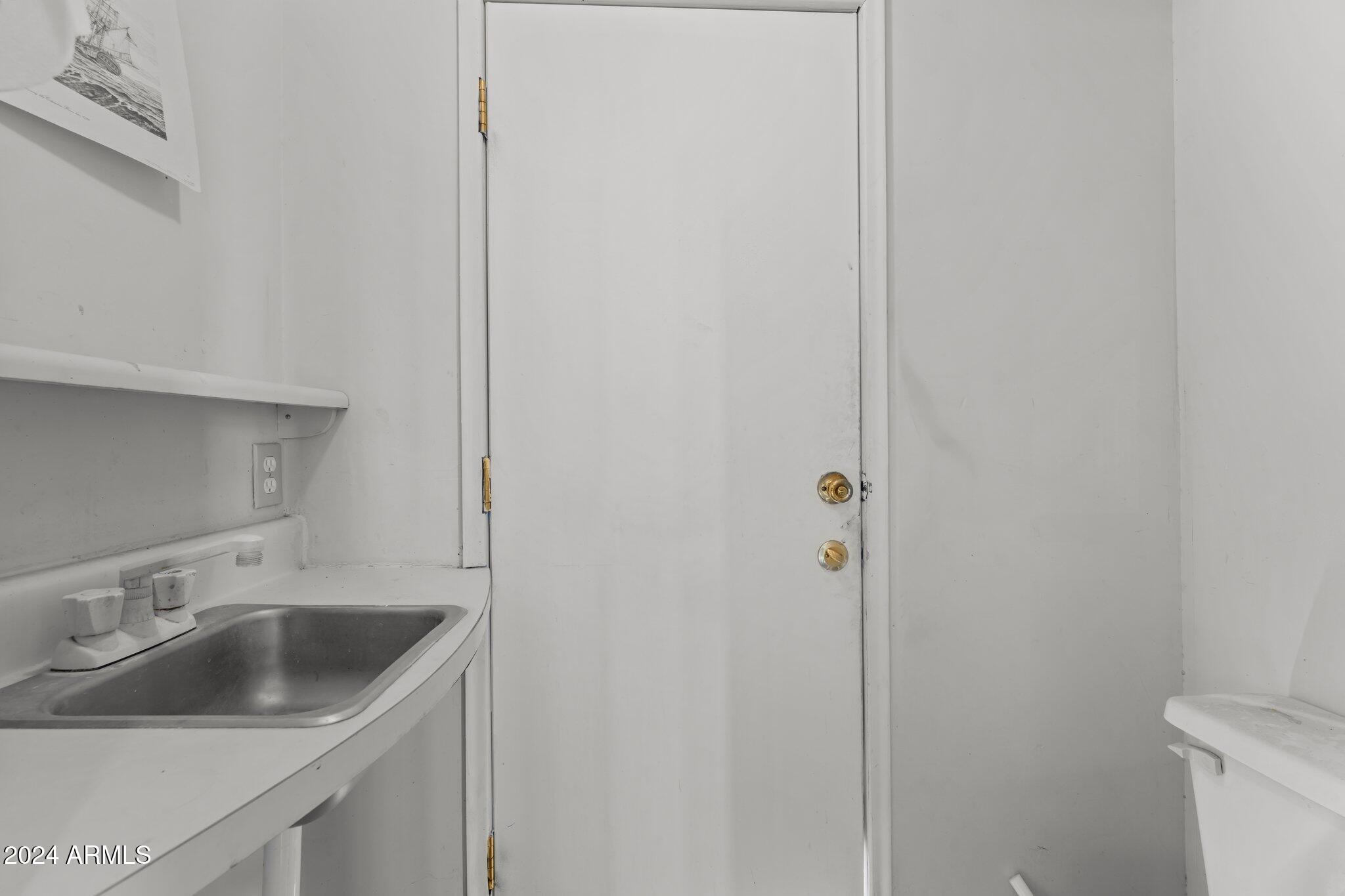 30857 Wandering Way Congress, AZ 85332 - Photo 31 of 35 a bathroom with a sink and mirror