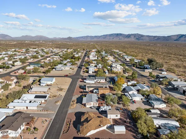 an aerial view of a city with lots of residential buildings and mountain view in back