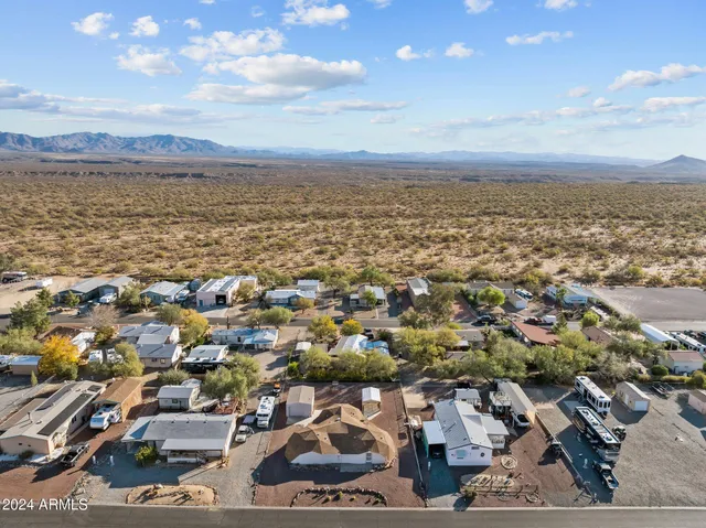 an aerial view of a city with lots of residential buildings and mountain view in back