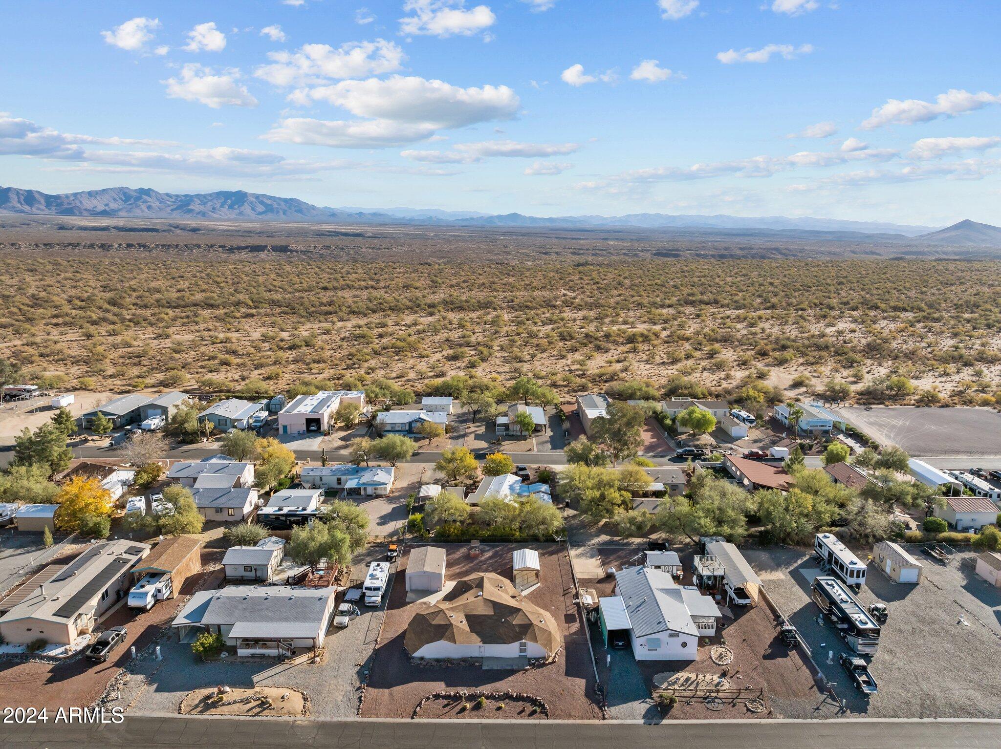 30857 Wandering Way Congress, AZ 85332 - Photo 5 of 35 an aerial view of a city with lots of residential buildings and mountain view in back