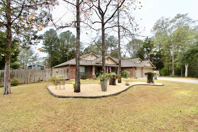a front view of a house with a yard patio and fire pit