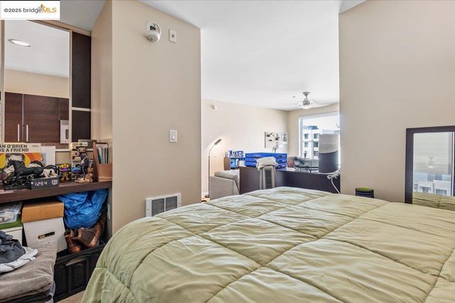 a large bedroom with a bed and a dresser