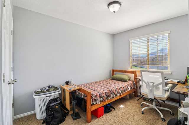 1077 South 1850th Street West Springville, UT 84663 - Photo 18 of 22 Bedroom with light colored carpet and an office area