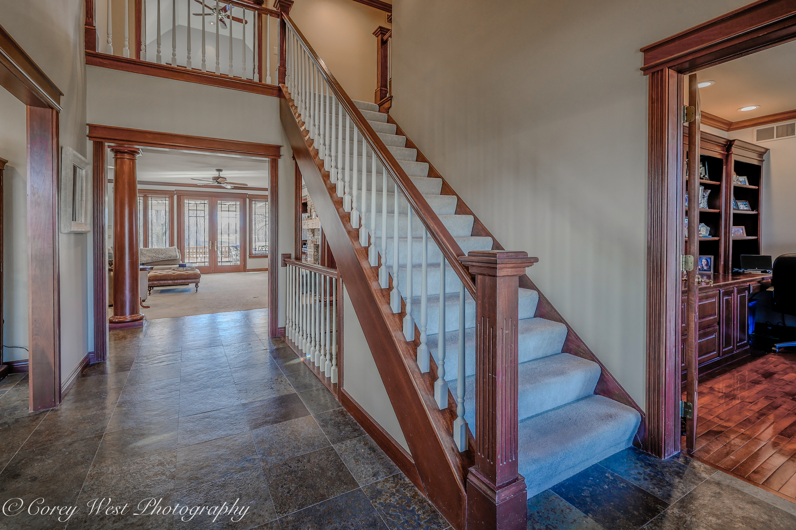 N004 Alexander Drive Geneva, IL 60134 - Photo 8 of 75 a view of a hallway with wooden floor and staircase