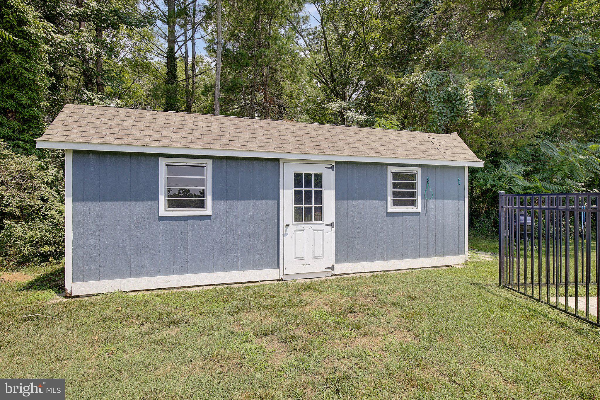980 Apple Lane Solomons, MD 20629 - Photo 60 of 82 Charming blue shed in serene setting.