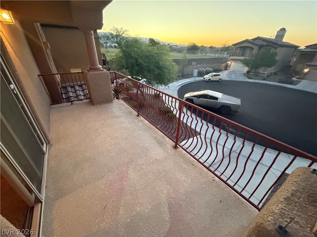 7629 Rory Court Las Vegas, NV 89129 - Photo 22 of 25 A private balcony offers serene views of the surrounding landscape and neighborhood at dusk.